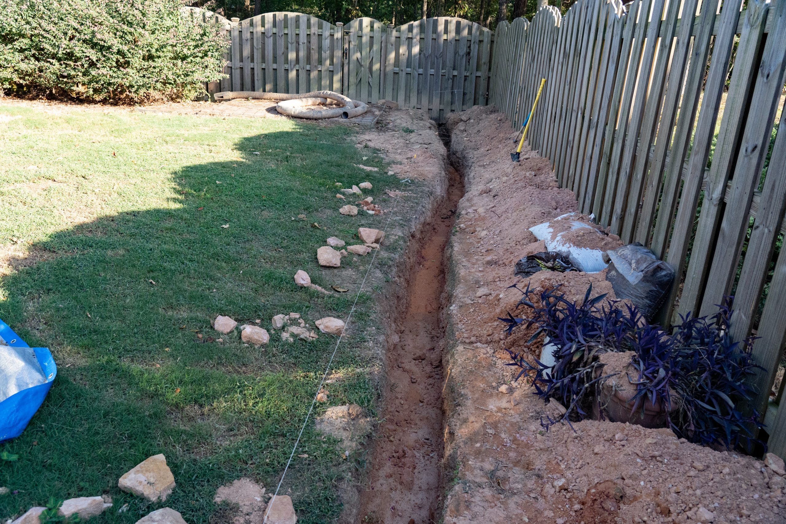 A trench is dug as the first step of a DIY French drain home